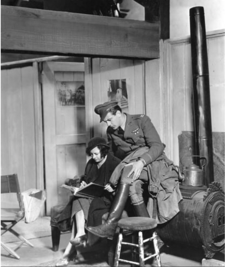 Gary-Cooper-looking-over-the-shoulder-of-the-script-girl-on-set-of-Howard-Hawkss-TODAY-WE-LIVE-1933